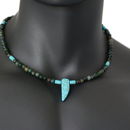 A beaded choker necklace for men featuring blue howlite and Indian agate with a tusk horn pendant on a mannequin.